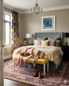 Second-hand blue Mashad Persian carpet with a traditional handknotted floral design, styled on the floor of a cozy bedroom